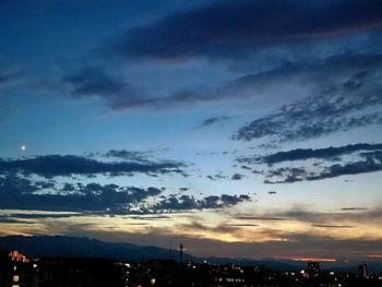 Silhouette cityscape against sky during sunset