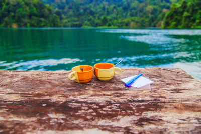 Close-up of drink on table by swimming pool