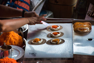 High angle view of person preparing food on table