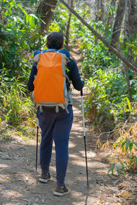 Traveler man hiking enjoying in the mountains with backpack at khao chang puak mountain thailand