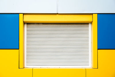 Full frame shot of yellow wall with windows