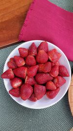 High angle view of strawberries in bowl on table