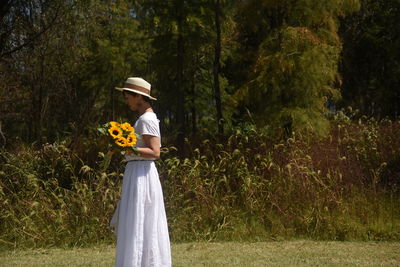 Rear view of woman standing on field