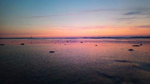 Scenic view of beach against sky during sunset