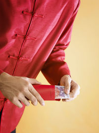 Midsection of man with paper currency in envelope during chinese new year