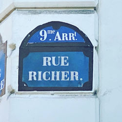 Close-up of information sign on wall