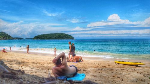 Scenic view of beach against cloudy sky