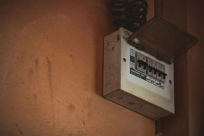 Close-up of telephone booth on wall