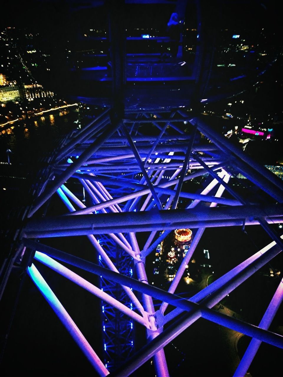 metal, built structure, night, low angle view, metallic, architecture, illuminated, indoors, engineering, pattern, arts culture and entertainment, no people, transportation, grid, bridge - man made structure, railing, geometric shape, connection, ferris wheel