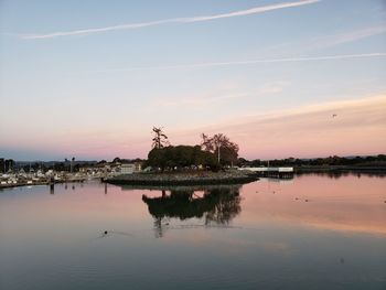 Scenic view of lake against sky at sunset