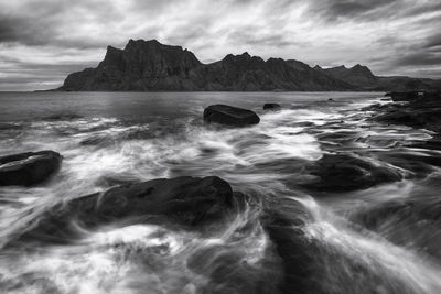 Blurred motion of sea against cloudy sky