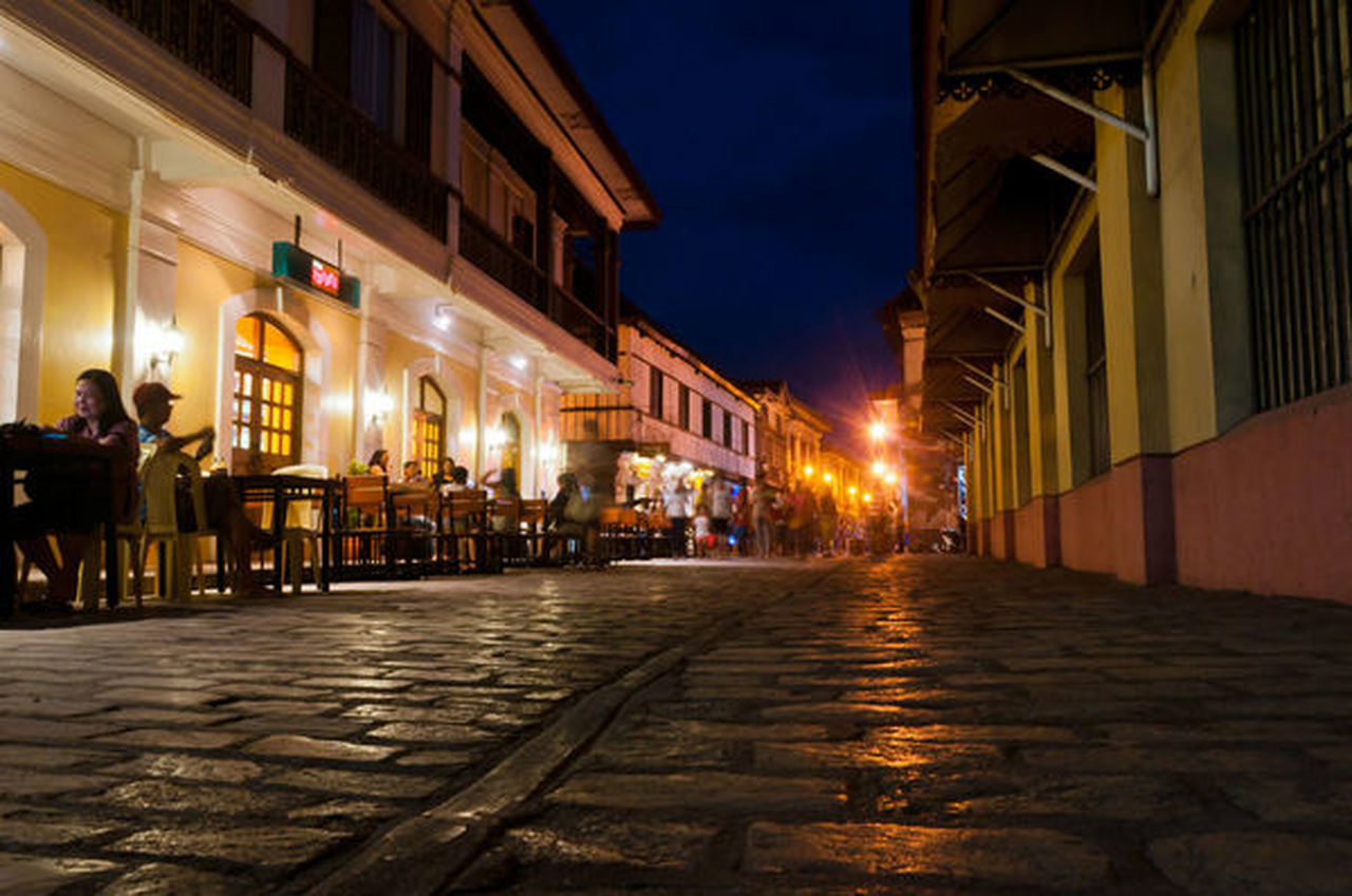 ILLUMINATED BUILDINGS IN CITY AT NIGHT