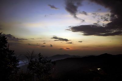 Scenic view of silhouette mountains against sky at sunset