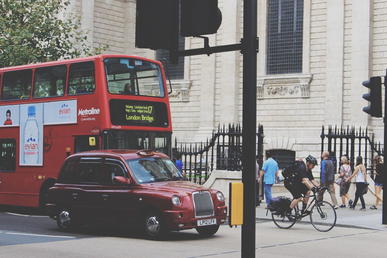 land vehicle, building exterior, architecture, transportation, built structure, mode of transport, city, car, street, bicycle, city life, city street, parked, stationary, travel, road, parking, incidental people, building