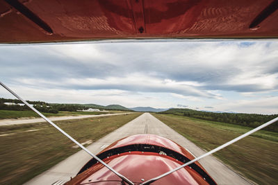 View from cockpit of vintage plane as it lands on runway in maine