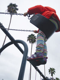 Low angle view of boy against sky