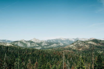 Scenic view of mountains against blue sky