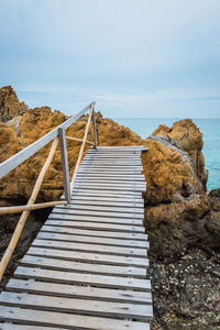 View of rocks on beach against sky