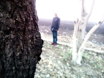 Woman holding tree trunk