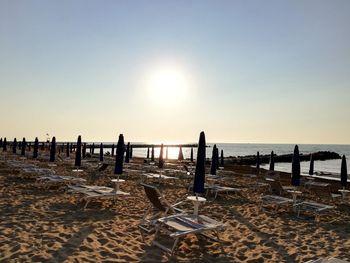 Scenic view of beach against clear sky during sunset