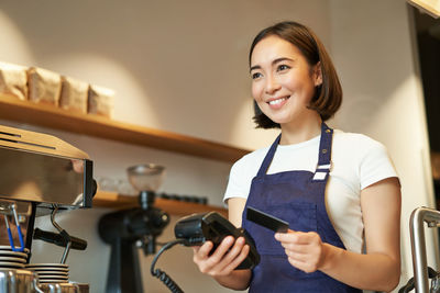 Portrait of young woman using mobile phone