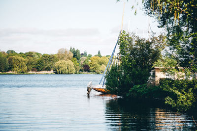 Sailboat in lake against sky