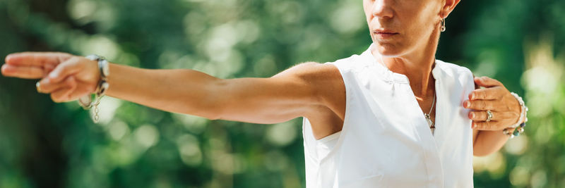 Qi gong female expert doing qigong exercises outdoor for moving chi