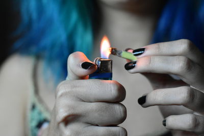 Close-up of hand holding candles