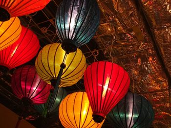 Low angle view of illuminated lanterns hanging at night