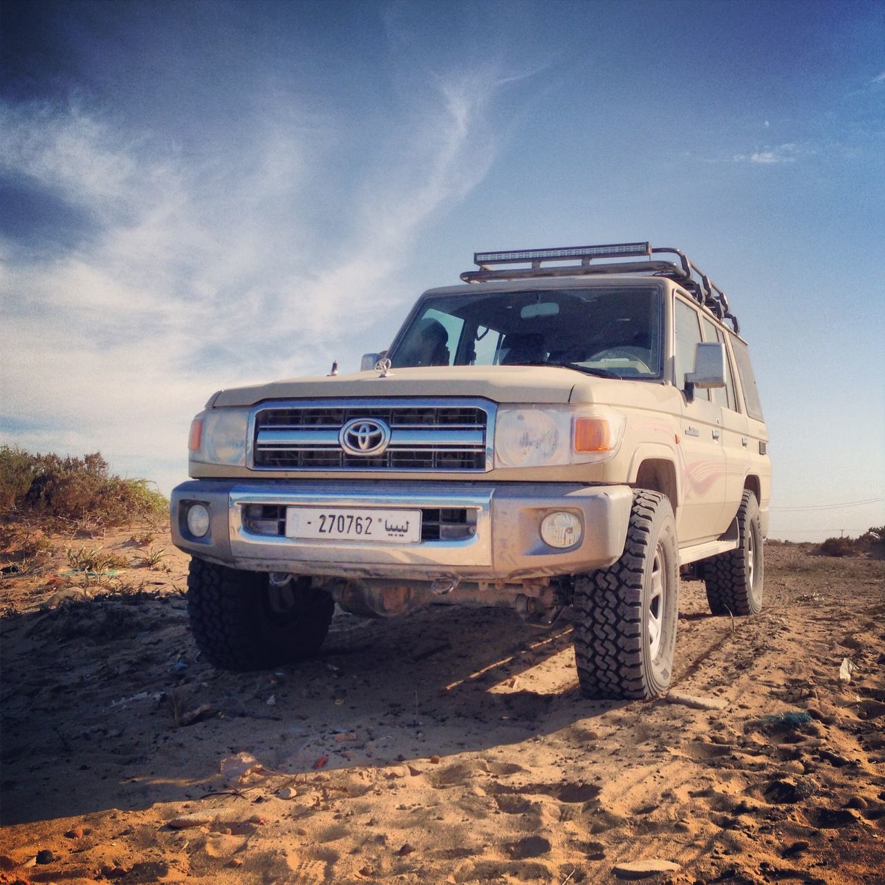 transportation, mode of transport, land vehicle, sky, car, cloud - sky, travel, abandoned, landscape, day, cloud, outdoors, stationary, field, no people, nature, sand, obsolete, damaged, public transportation