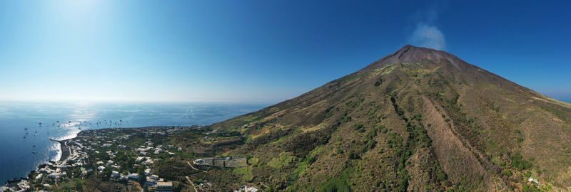 Panoramic view of volcanic landscape against blue sky