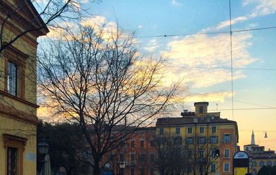 Low angle view of buildings against cloudy sky