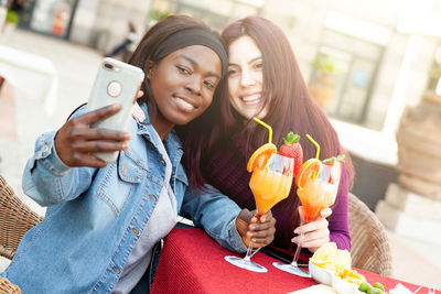 Portrait of young woman using mobile phone