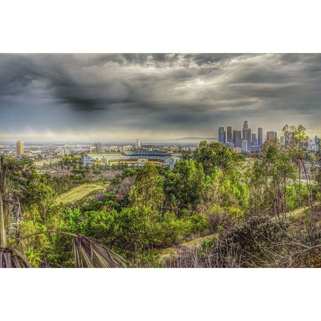 transfer print, auto post production filter, sky, building exterior, cloud - sky, tree, built structure, architecture, cloudy, growth, city, overcast, weather, cloud, nature, green color, outdoors, no people, day, landscape