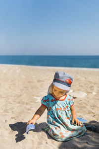 Full length of child on beach against sky