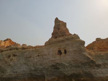 Rock formations on land against sky