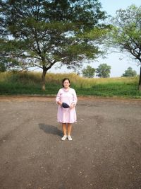 Full length portrait of girl standing on road