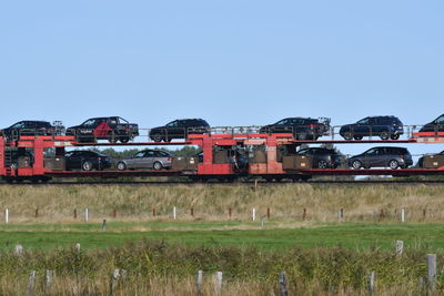 Train on field against clear sky