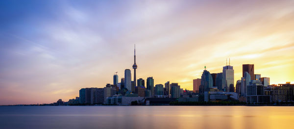 Modern buildings in city at sunset