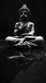 Close-up of statue against black background
