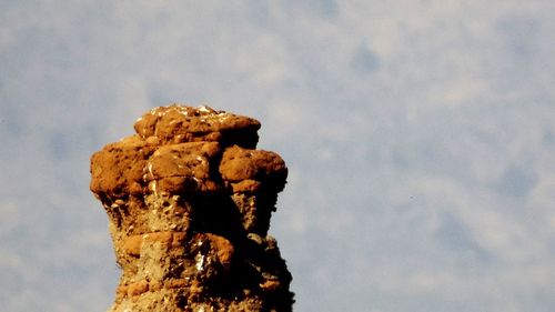 Low angle view of rock against sky