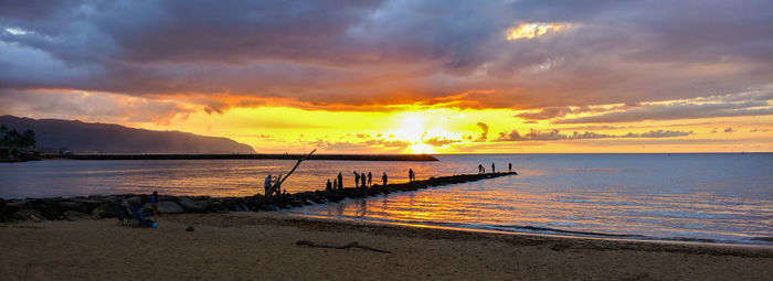 Scenic view of beach against sky during sunset