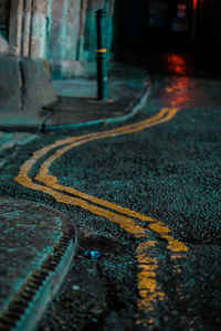 High angle view of double yellow lines on road at night