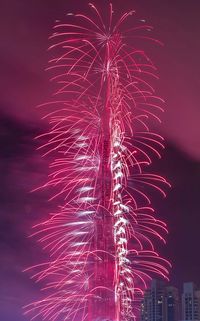 Low angle view of firework display at night