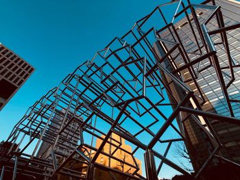 Low angle view of crane against blue sky