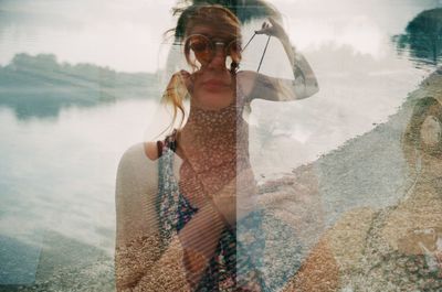Multiple exposure of young woman and lake