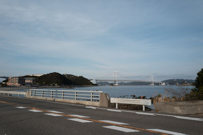 View of the naruto bridge over the naruto strait over the road and sea.