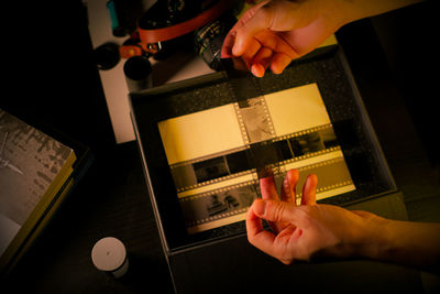 Cropped hand of man using smart phone