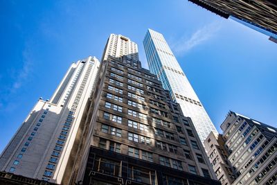 Low angle view of modern buildings against clear blue sky