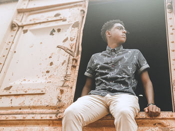 Low angle view of young man looking away